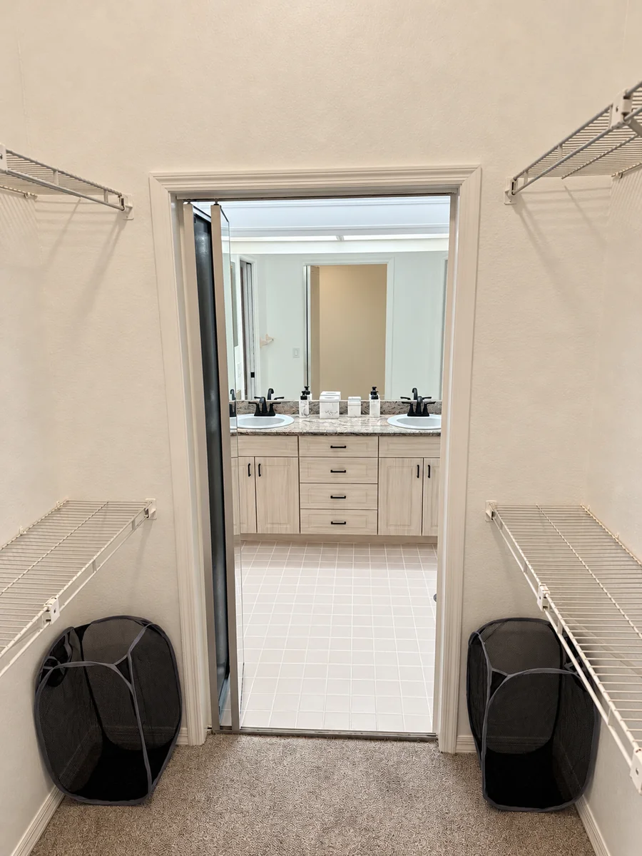 Closet with wall-mounted shelving and hanging rails