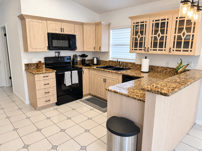 Full kitchen with granite counters and breakfast bar